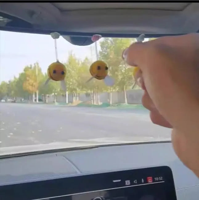 Yellow and black cartoon bee car decoration made from fur ball material measuring 3x3cm