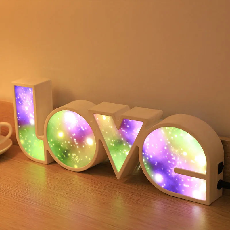 LED decorative light with rainbow-coloured LOVE word on plastic shade