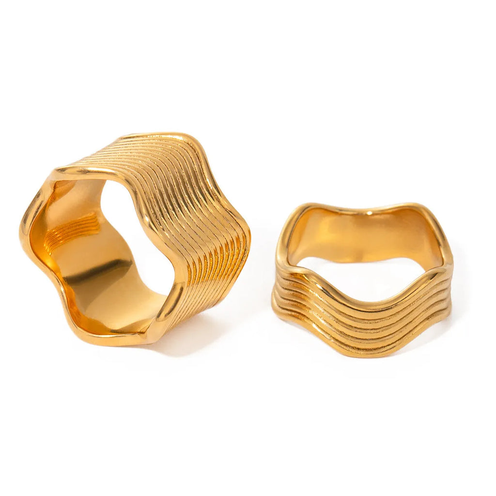 Geometric wide band stainless steel wave ring for women with electroplated finish.
