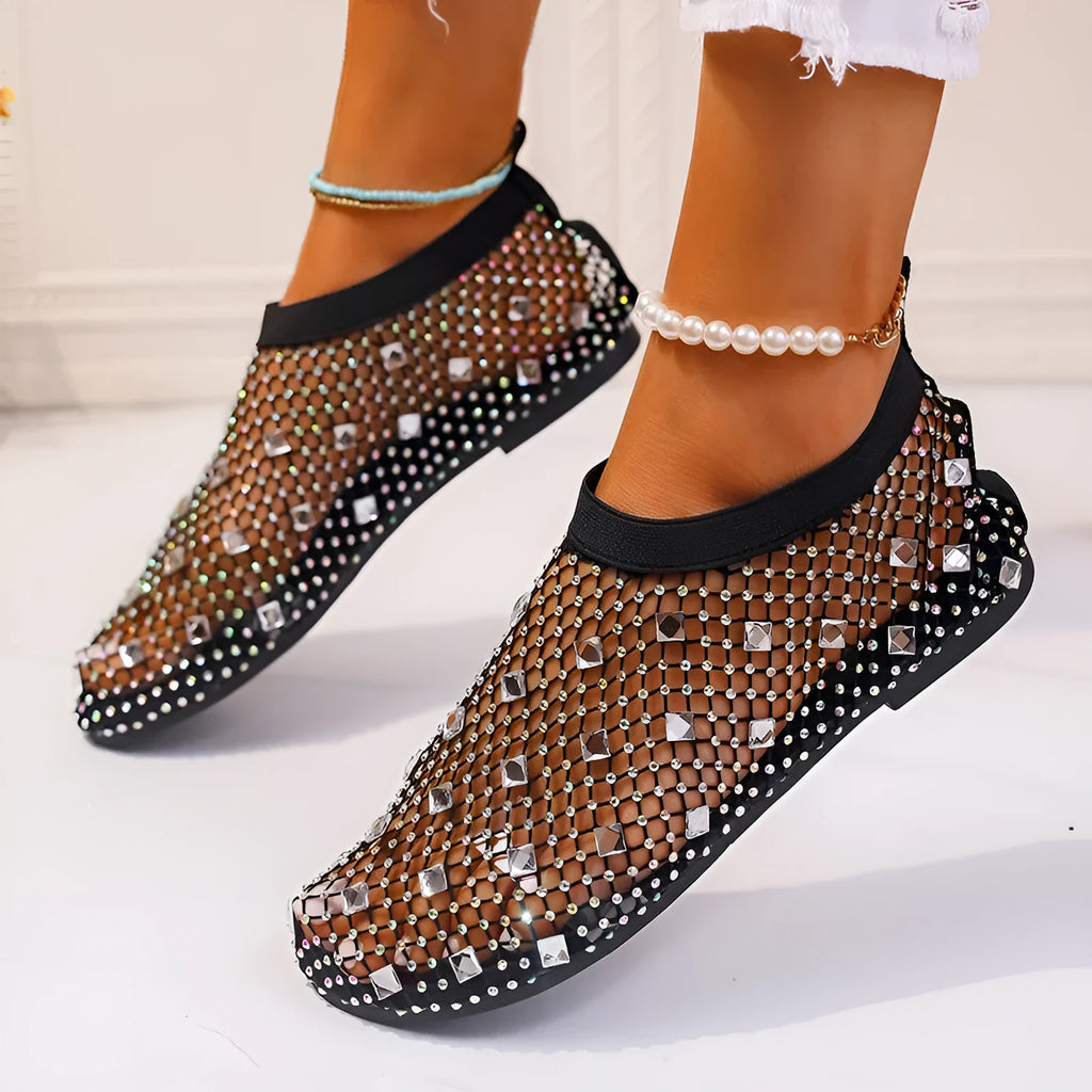 Women's flat sandals with mesh upper, colourful rhinestone decoration, and a rubber sole.