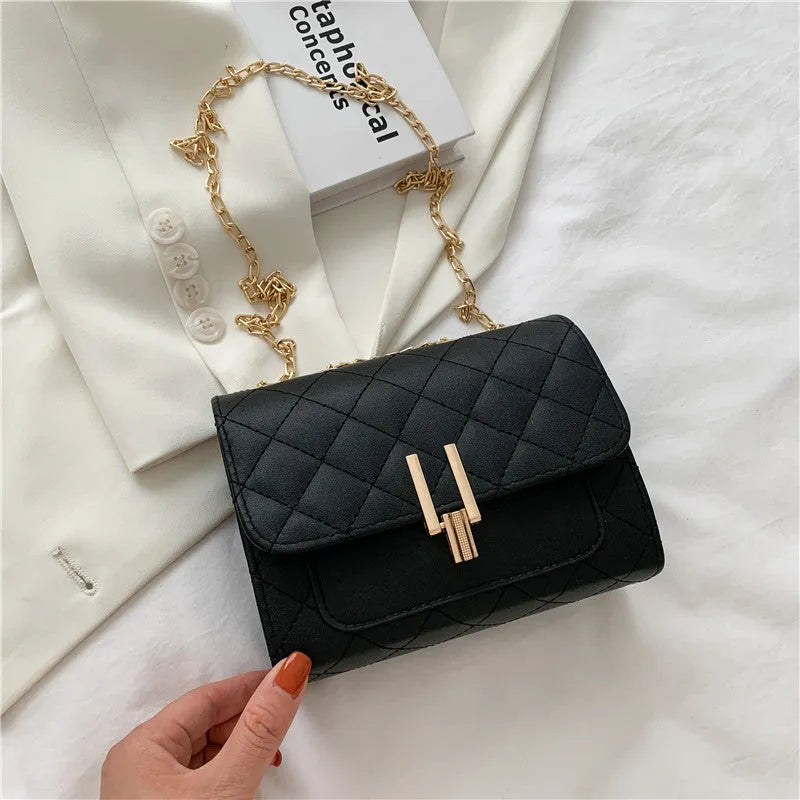 Women's diamond lattice chain crossbody bag in black with adjustable strap
