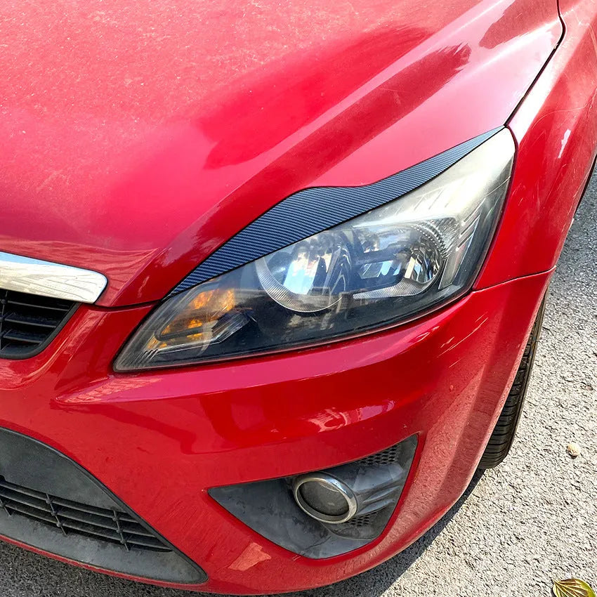 Ford Focus front headlight with carbon fiber pattern ABS eyebrow decal applied for external decorative modification