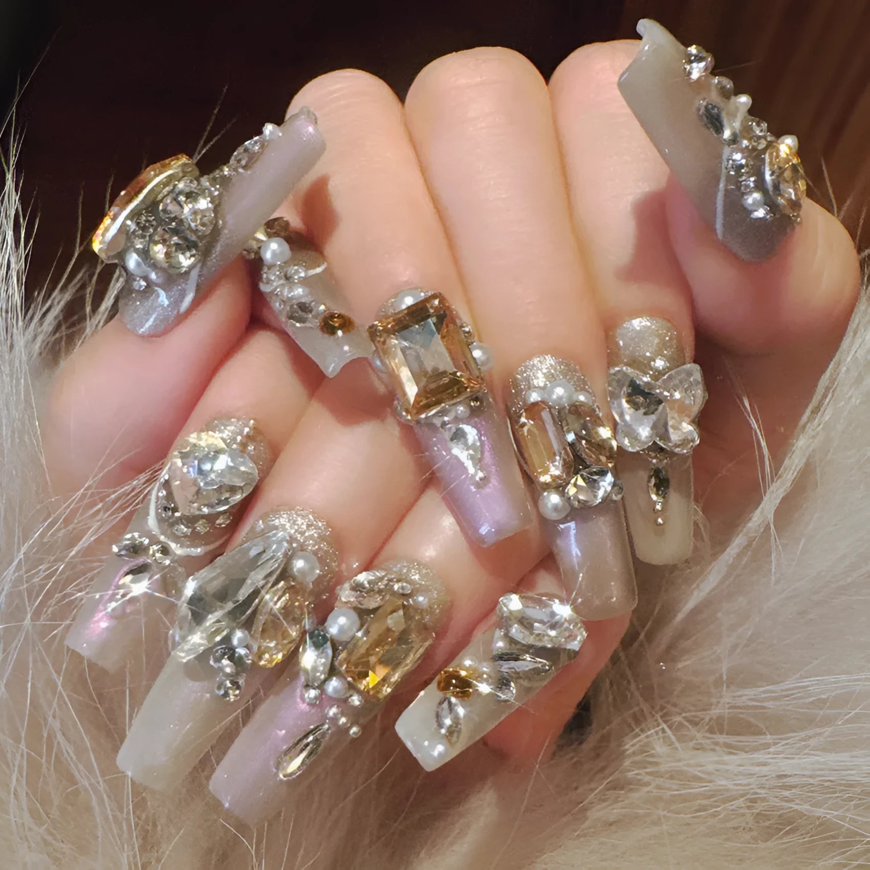 False nail patches with rhinestone detail on card paper packaging showing S number sizing