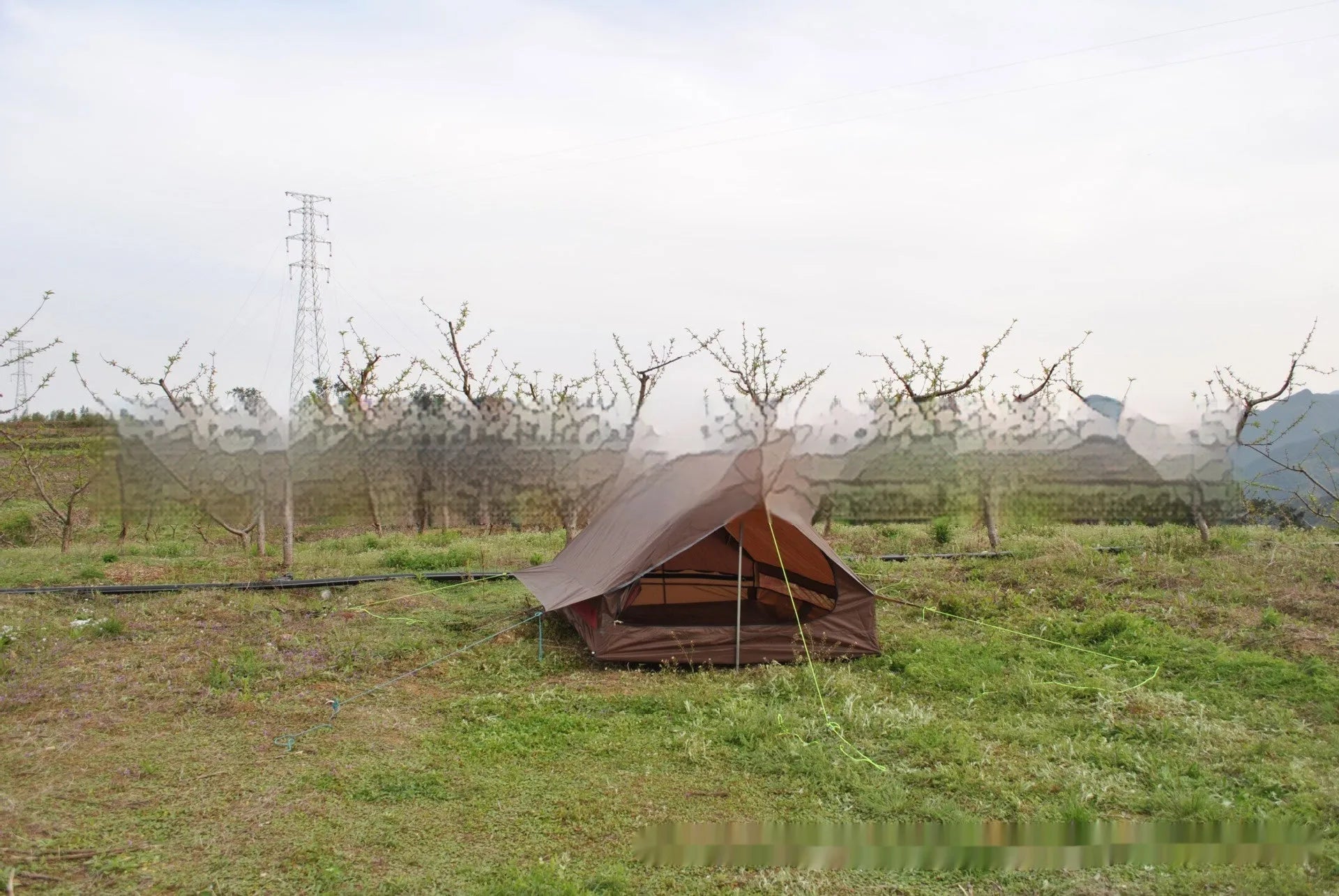 Brown or white A-line pole-free cabin tent for hiking, shown packed and pitched.