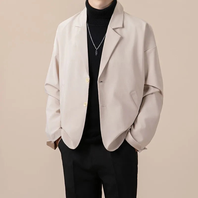 Men's loose fit light business style suit jacket in a polyester blend fabric, shown on a hanger.