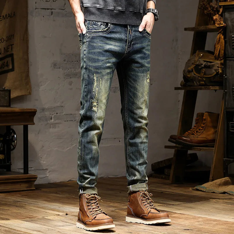 Men's skinny fit retro blue jeans with a zip fly closure laid flat.