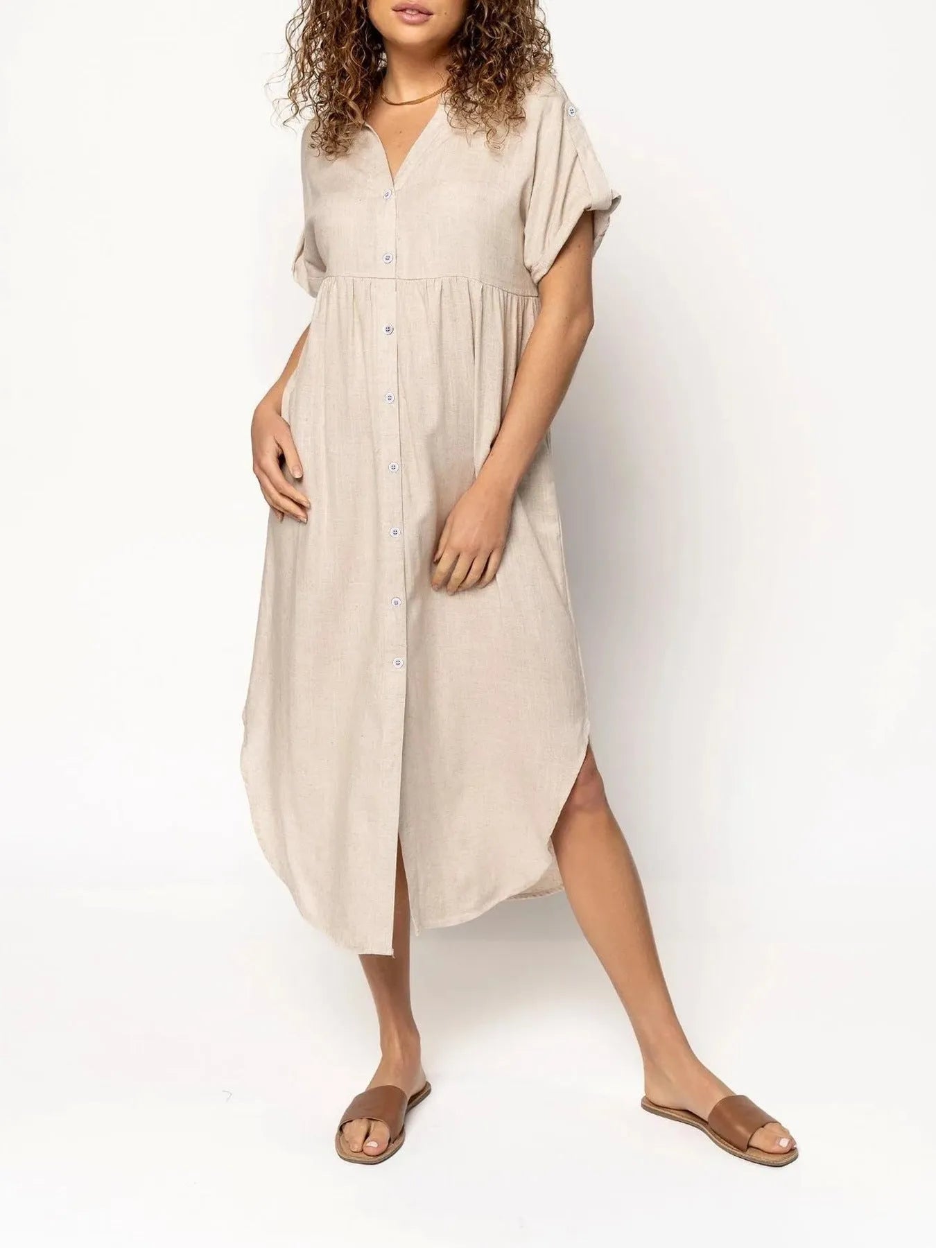 Loose-fitting casual solid colour button dress in a mid-length style on a hanger.