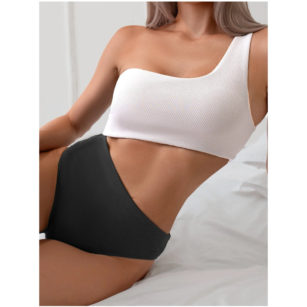 Light grey one-shoulder one-piece swimsuit on a model