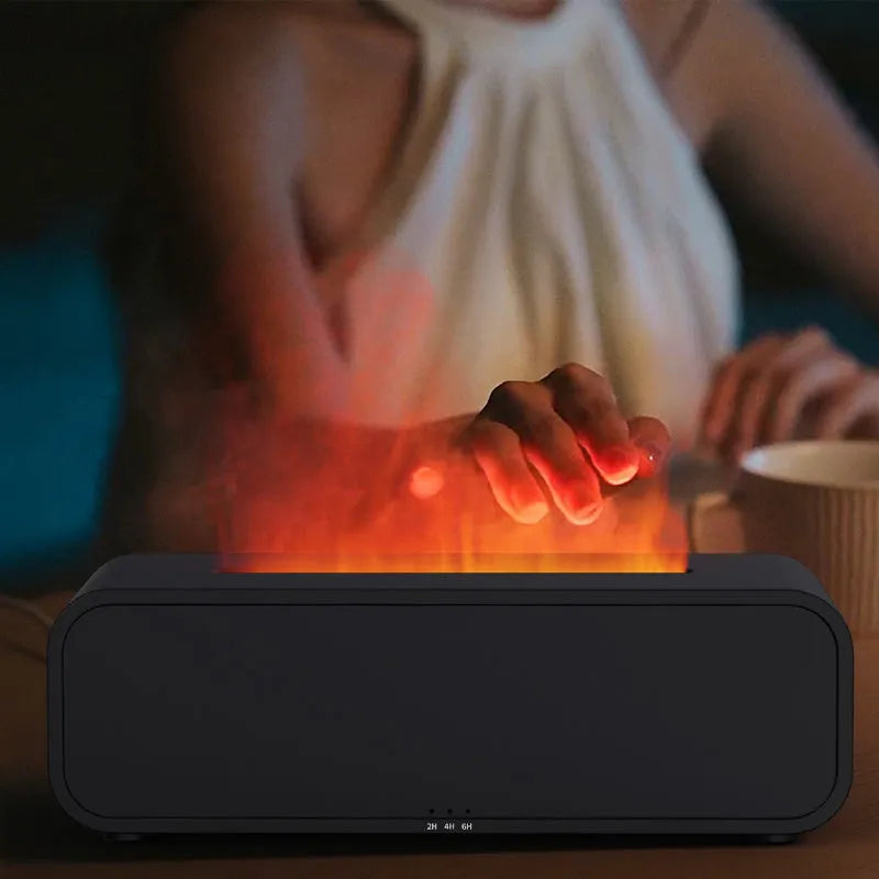Black and white flame effect aroma diffuser with remote control on a table