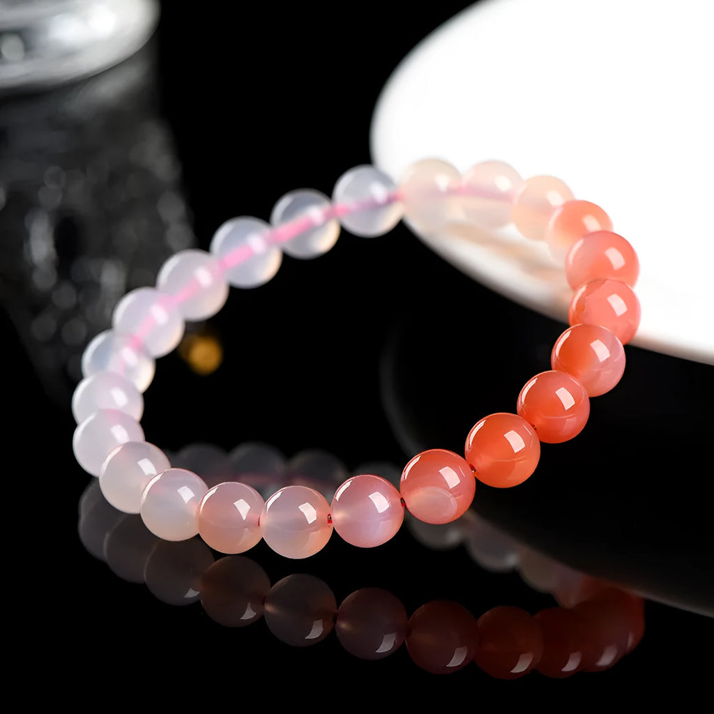 Natural gradient Yanyuan agate bracelet with geometry-shaped beads on a wrist.