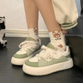 Green women's casual shoes with mesh upper, flat heels, and round toe design