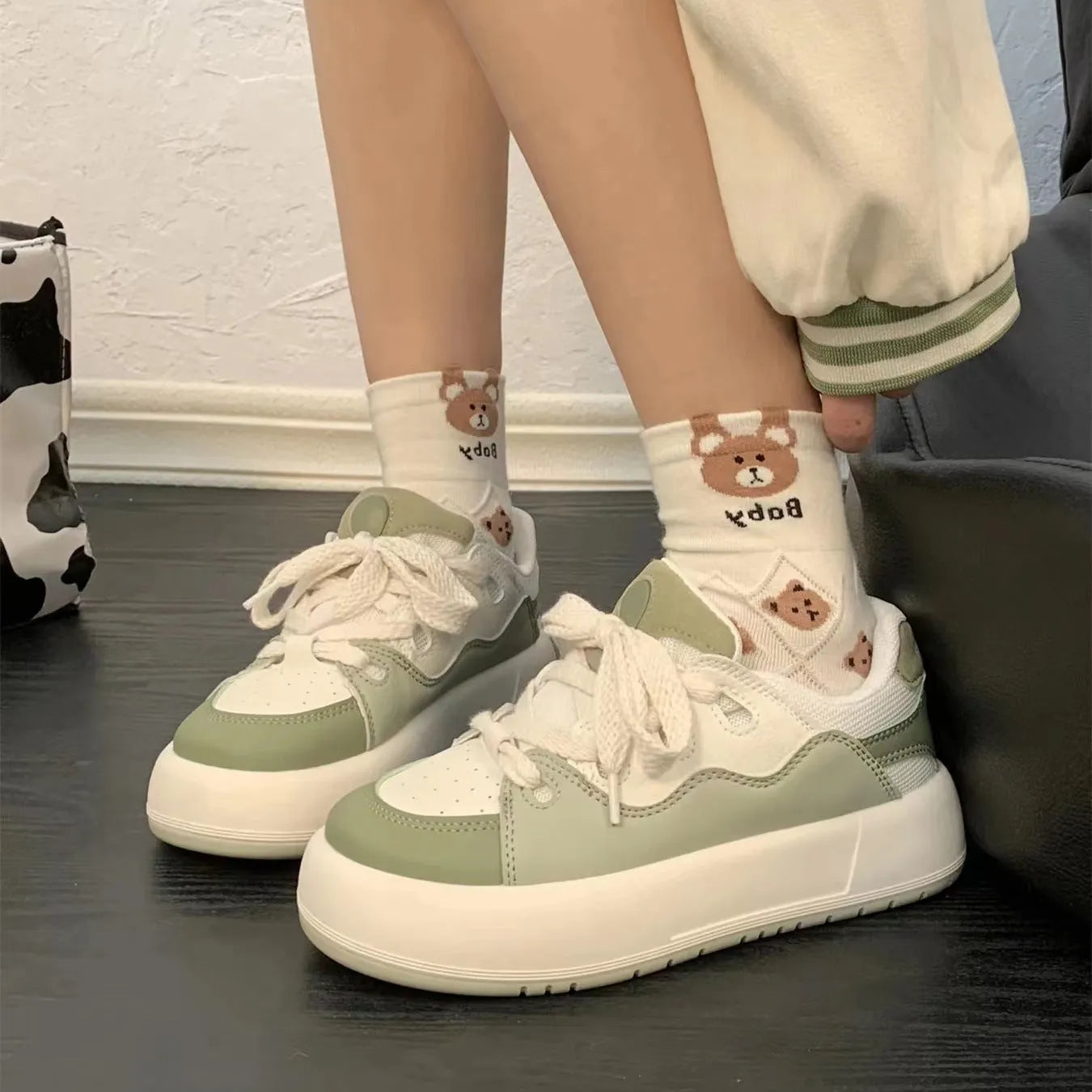 Green women's casual shoes with mesh upper, flat heels, and round toe design