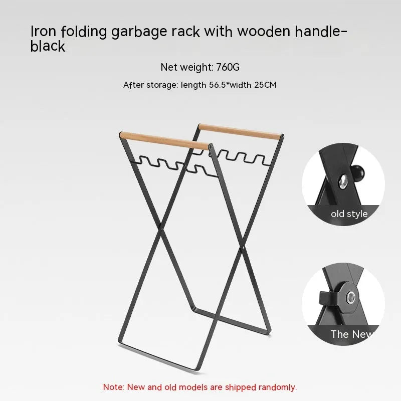 Black outdoor folding iron trash rack with a wooden handle, holding a bin bag.