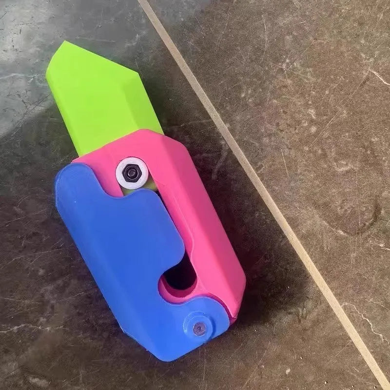 Carrot-shaped 3D printed plastic gravity fidget knife with orange purple green colour scheme