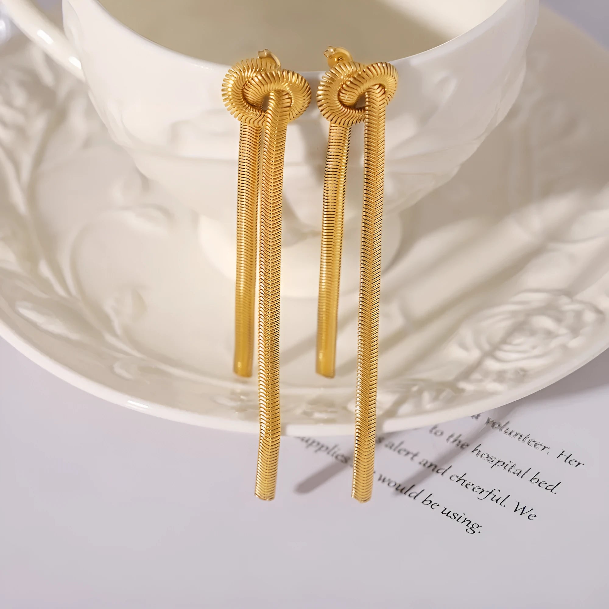 Gold knotted tassel necklace and matching earrings set on titanium steel snake chain