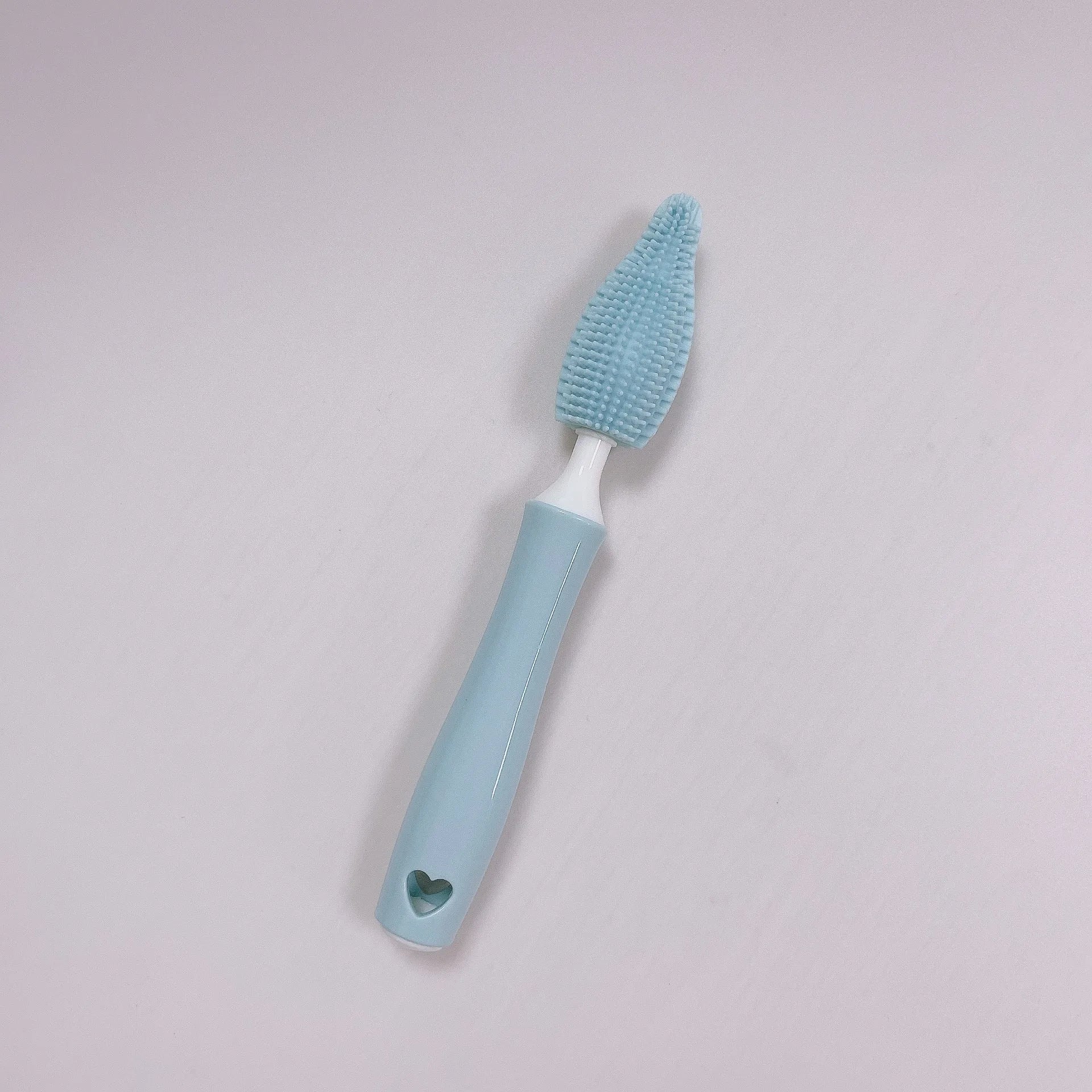 Blue, pink, and yellow silicone baby bottle brushes with an integrated straw cleaning tool.