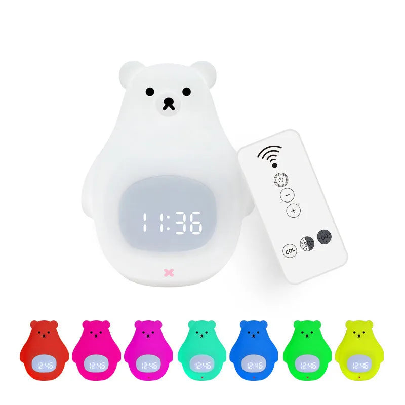 White silicone bear-shaped night light with a remote control on a wooden surface.
