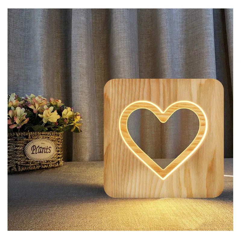 Solid wood hollow night lamp with warm white LED light on a surface.