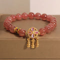 Women's strawberry quartz crystal bracelet with four leaf dream catcher pendant.