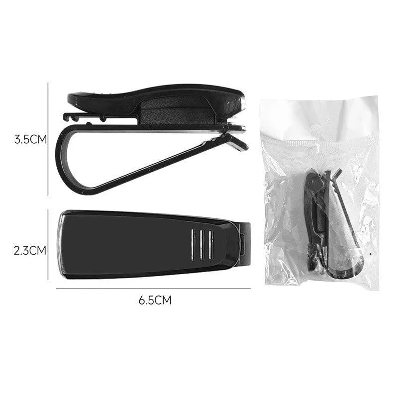 Black plastic clip for holding glasses and cards on a car sunshade