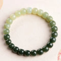 Natural Hetian jade bracelet showing water gradient colour variation on polished surface