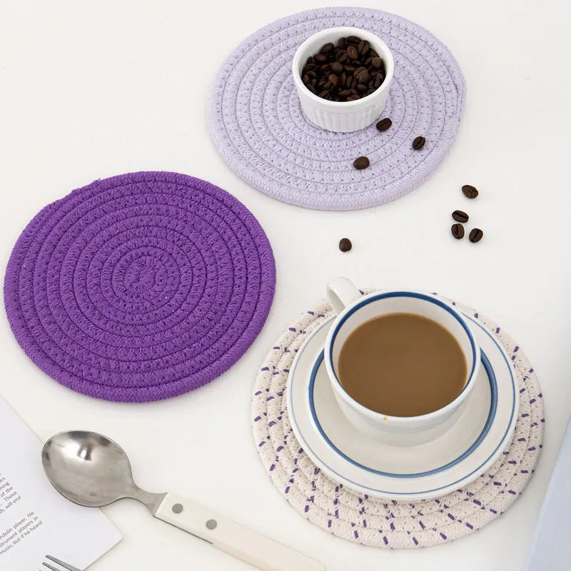 Set of three round grey cotton cord coasters, each 18 cm in diameter, on a wooden table.
