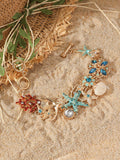 Women's alloy marine-themed bracelet with boat anchor, shells, starfish and rhinestones in turquoise, red or blue.