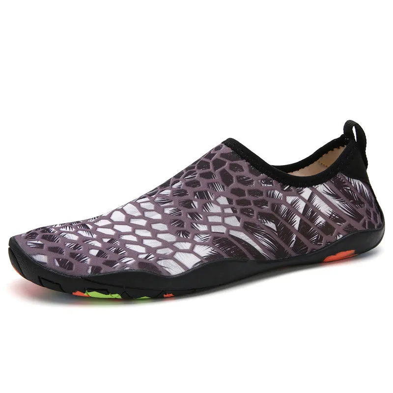 A pair of beach wading shoes for swimming, shown in camouflage colour with Lycra upper and EVA sole.