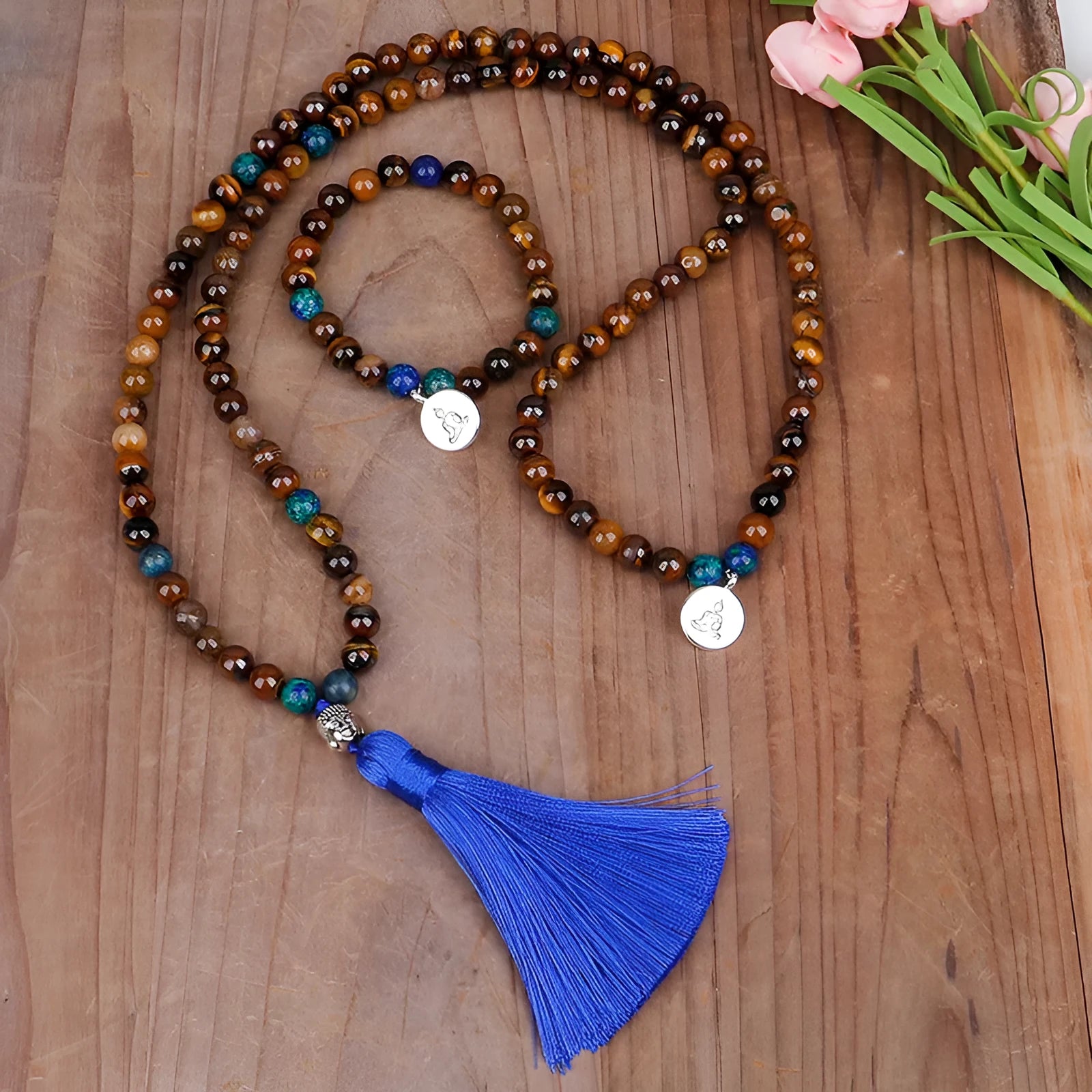 Handmade tiger eye stone bead necklace with tassel pendant and matching bracelet on a neutral background