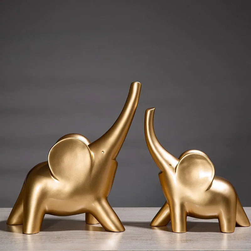 Modern minimalist solid resin elephant ornament in rose gold or white finish on a shelf.