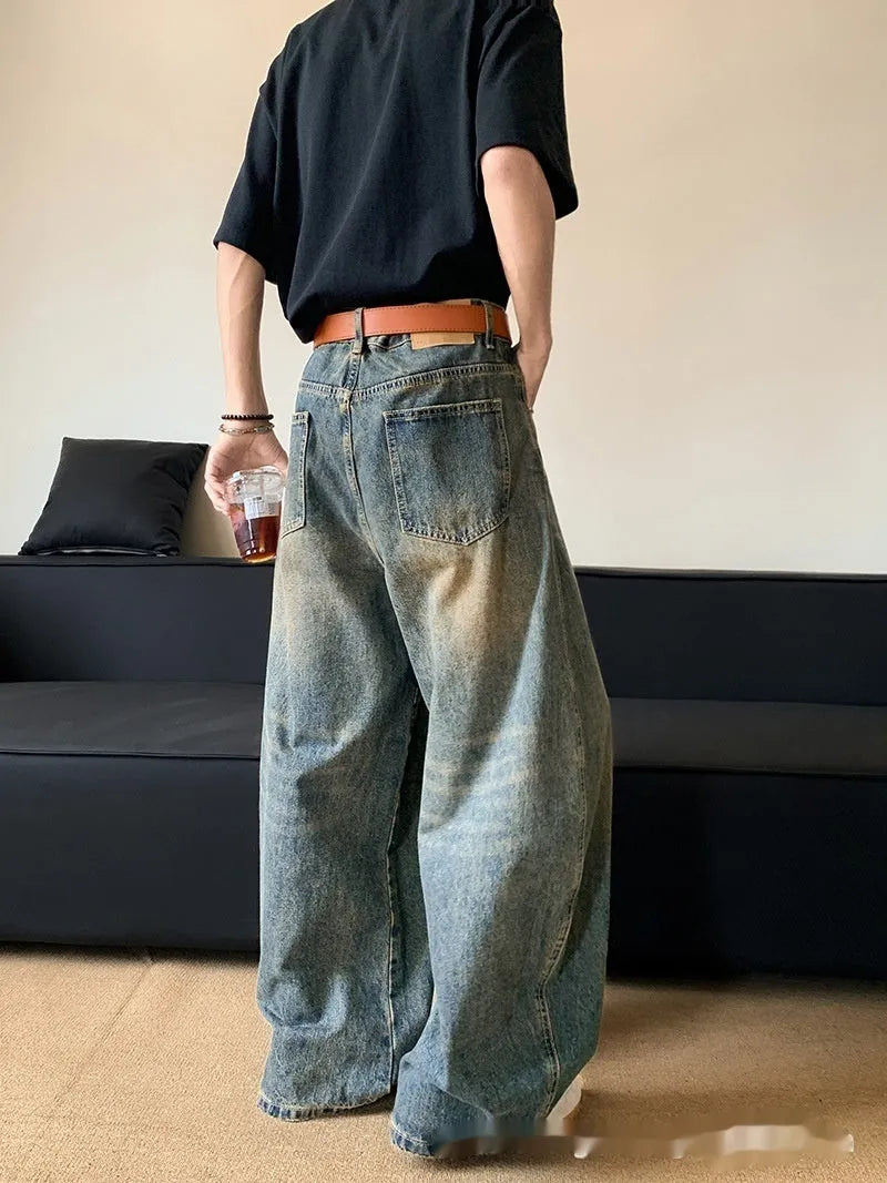 Men's retro blue wide-leg jeans with distressed detailing and machete wash effect