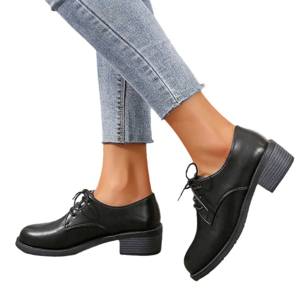 Black women's low-top work shoes with a chunky heel, rounded toe, and soft rubber sole.