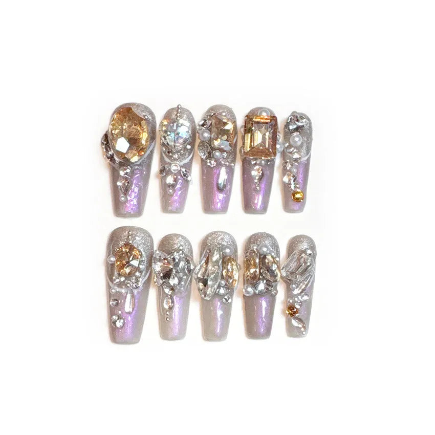False nail patches with rhinestone detail on card paper packaging showing S number sizing