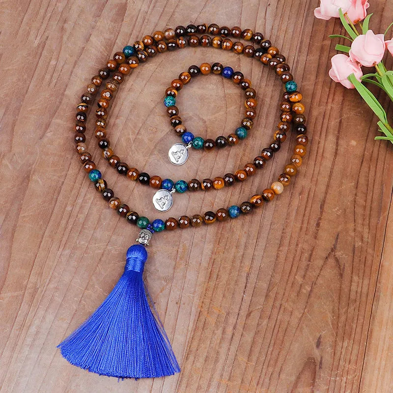 Handmade tiger eye stone bead necklace with tassel pendant and matching bracelet on a neutral background