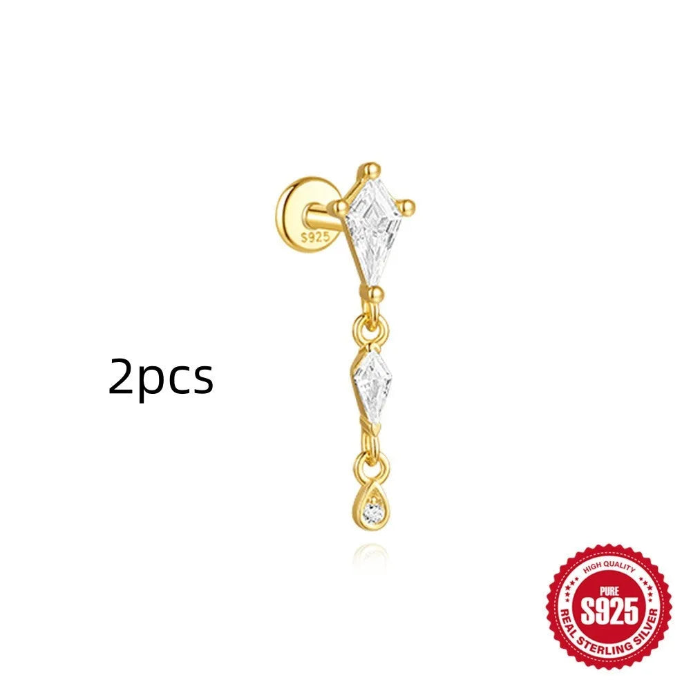 Geometric kite-shaped sterling silver stud earrings with rhinestones and a gold chain tassel.