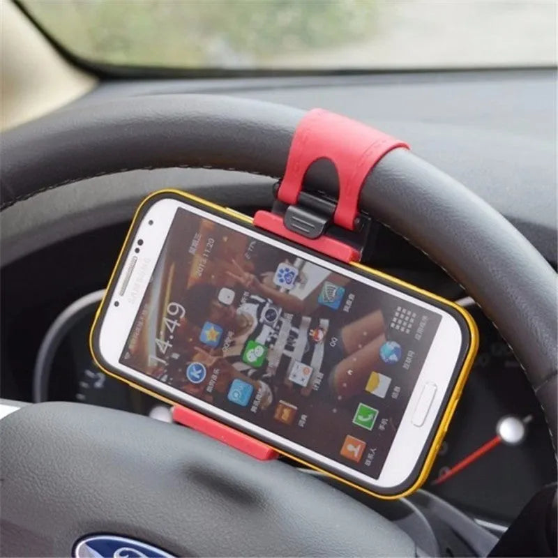 Black universal steering wheel phone holder clip mounted on a car steering wheel with a smartphone secured.