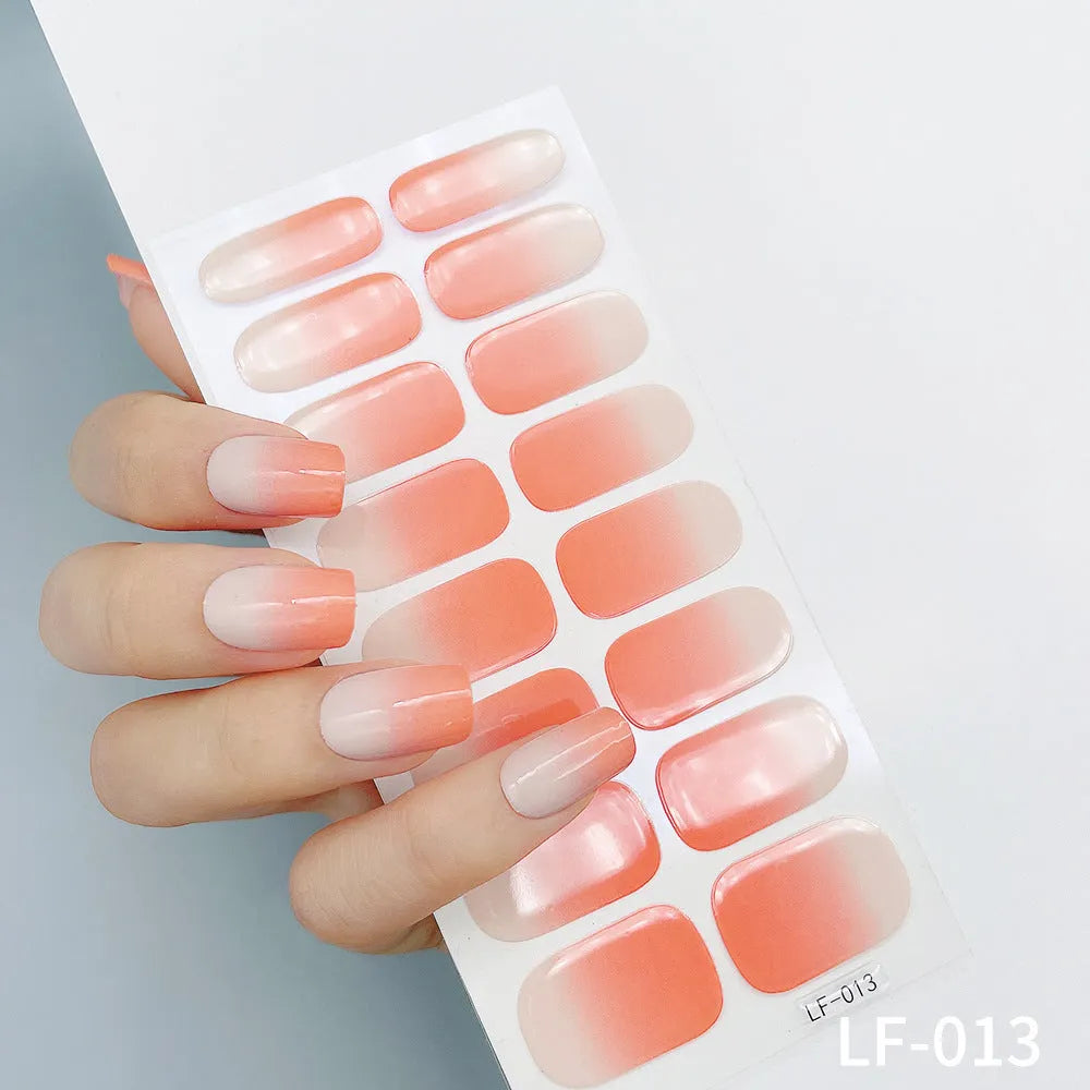 Full sheet of nail art stickers showing sixteen small designs including cross, rose, tulip, and leopard print patterns.