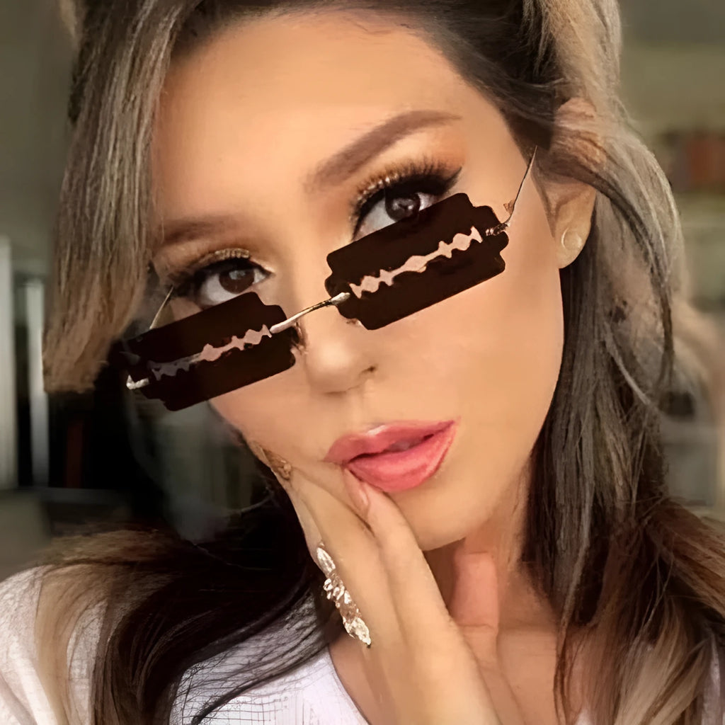 Women's metal rimless frameless sunglasses with gold frame and blue lens on display