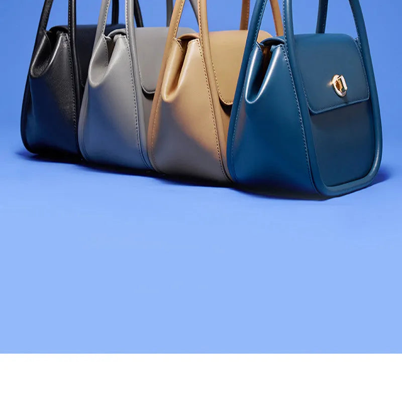 Women's leather wing tote bag with cross-body strap and latch closure in various colour options