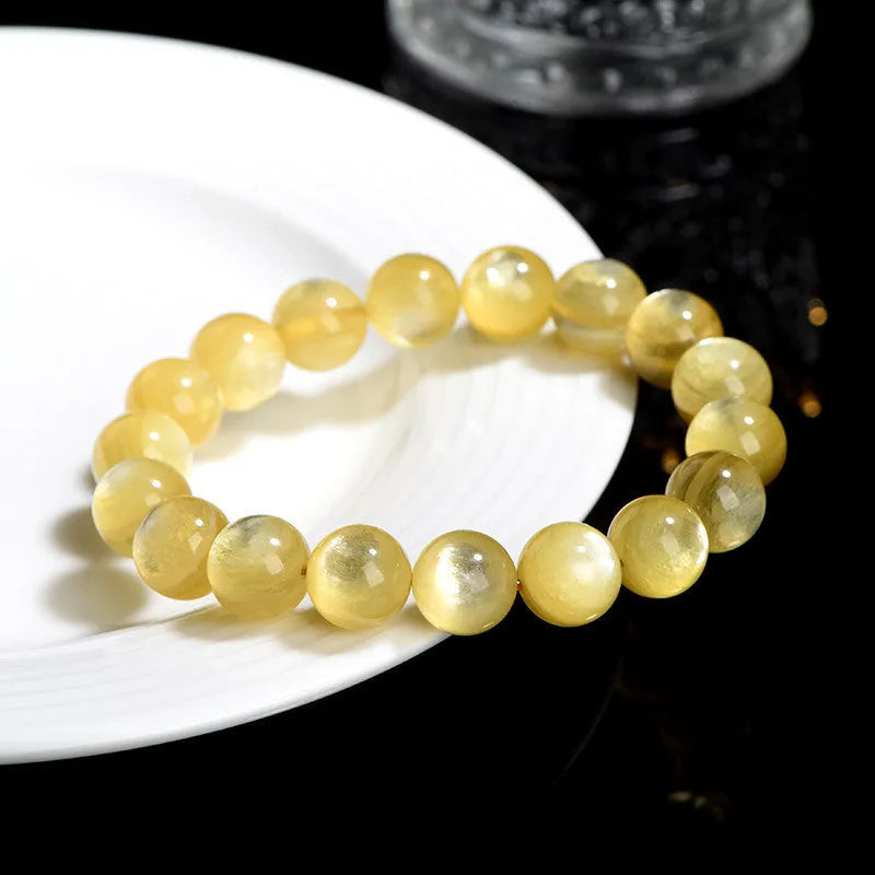 Yellow dragon gold lepidolite mica bead bracelet with geometric round beads on wrist