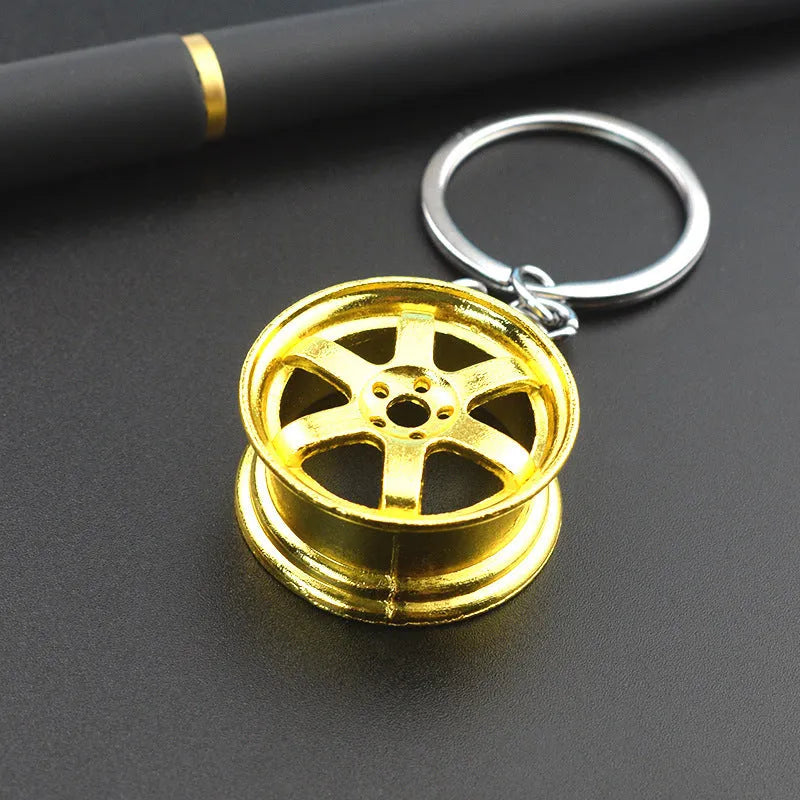 Zinc alloy wheel hub car keychain in gold, silver and gun black colour options