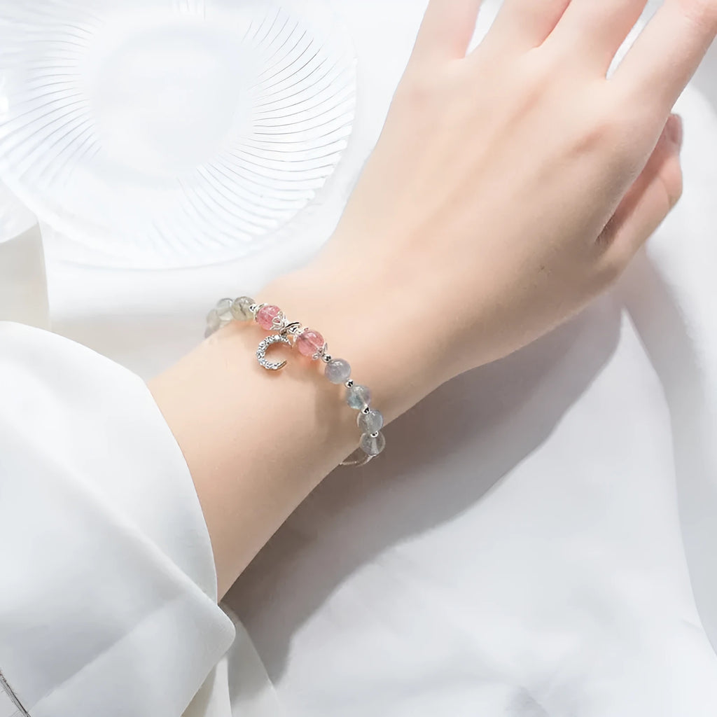 Natural moonstone bracelet with extension chain showing crescent moon and crystal accents