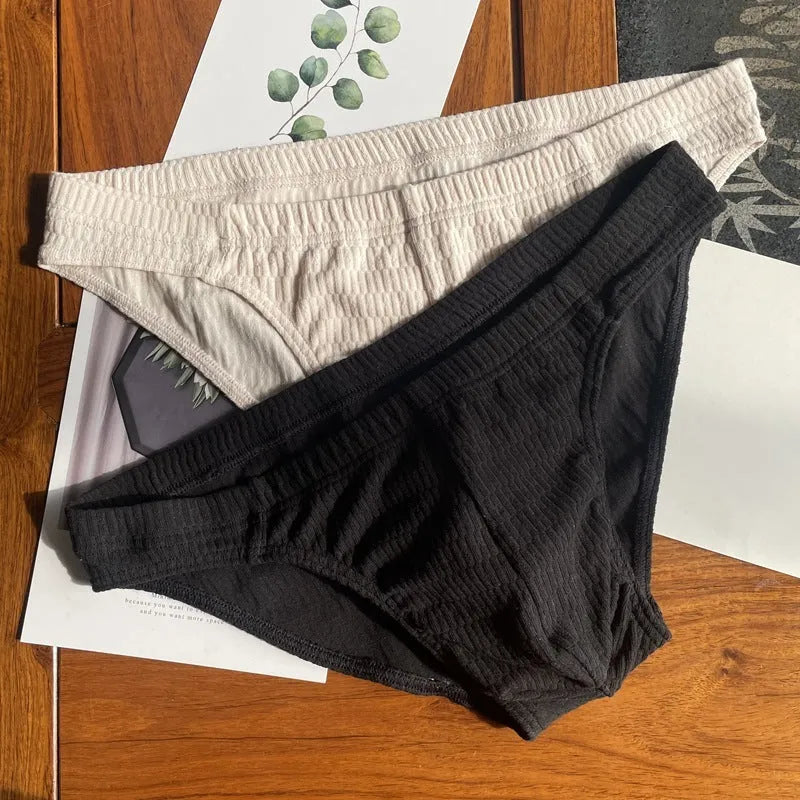 Men's solid colour cotton triangle briefs in apricot, shown from the front on a mid-waist fit model.