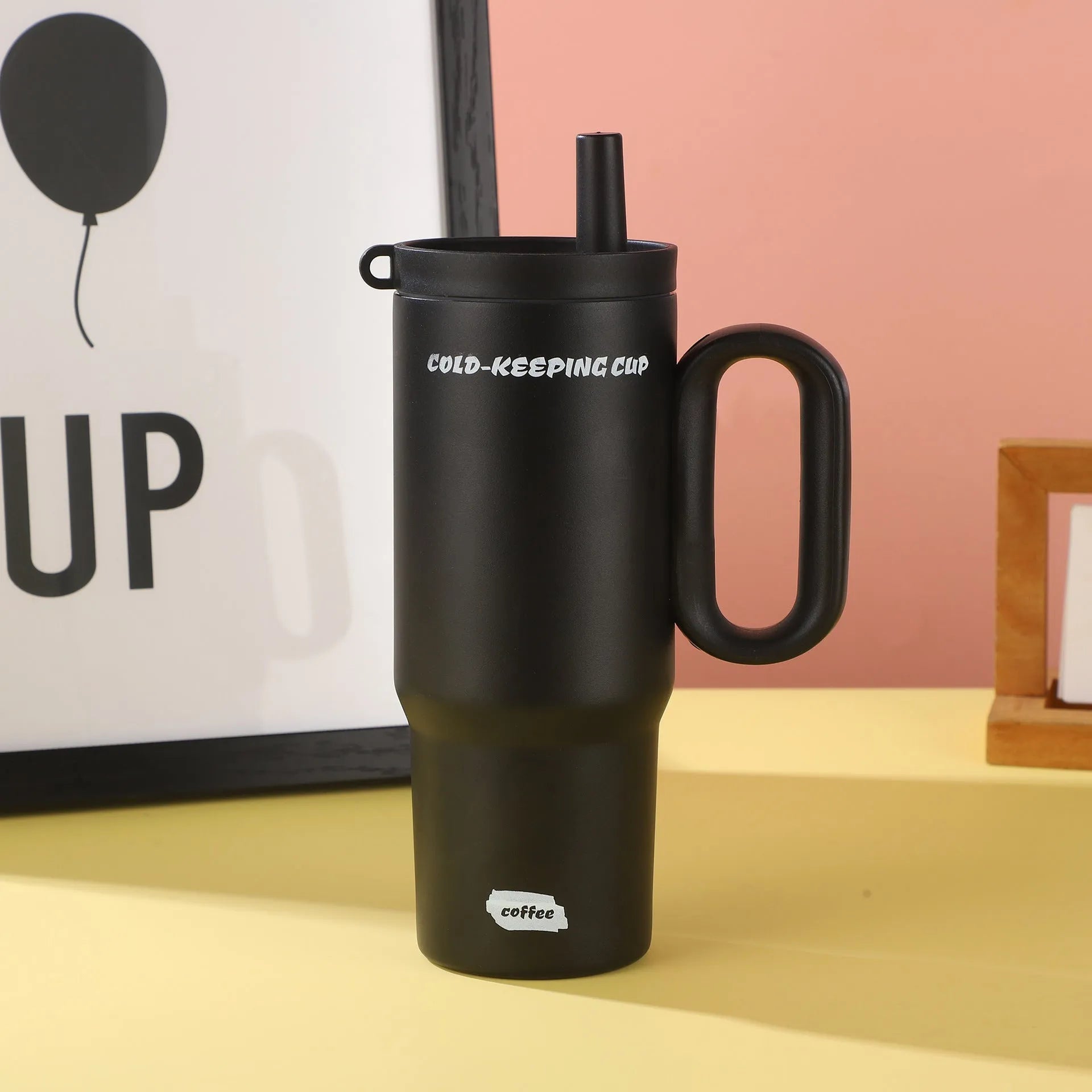 Large insulated plastic straw cup with a carry handle and lid, shown in assorted colours.