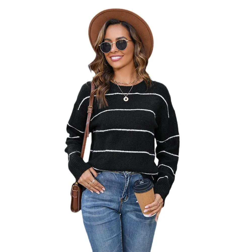 Women's loose-fit striped pullover sweater with round neck, shown in black and white colour options.