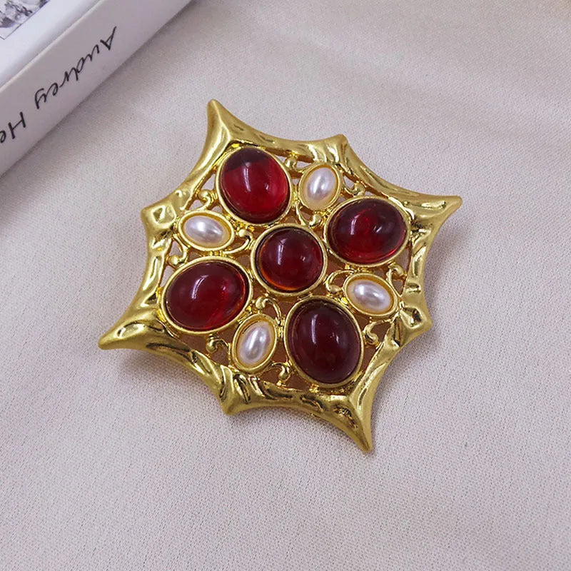 Close-up of a vintage medieval baroque cross brooch with crystals, made from zinc alloy.