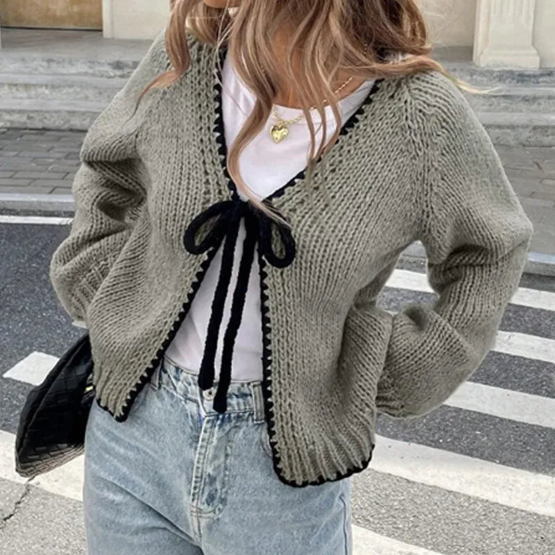 Gray lace-up front cardigan sweater with white crochet flower details and loose long sleeves.