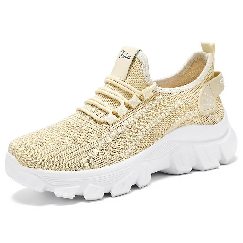 Women's white Flyknit sneakers with round toe and flat heel on a thick PVC sole.