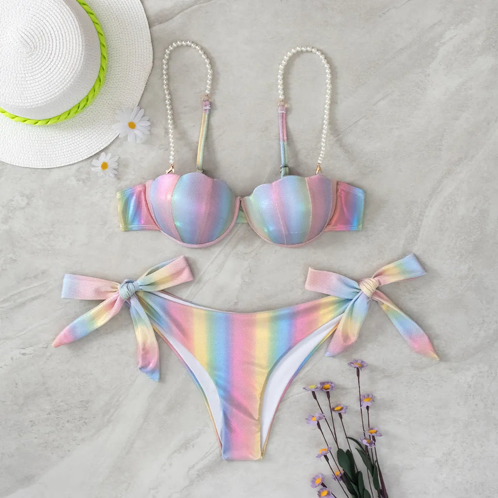 Women's rainbow shell bikini swimsuit with adjustable ties on top and bottom.