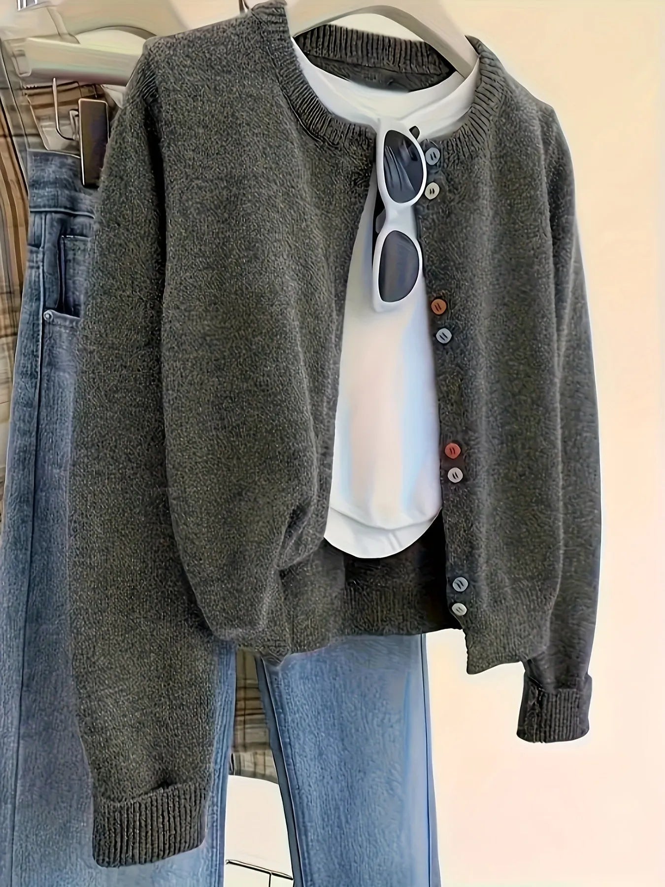 Dark grey women's button-front cardigan sweater with long sleeves.